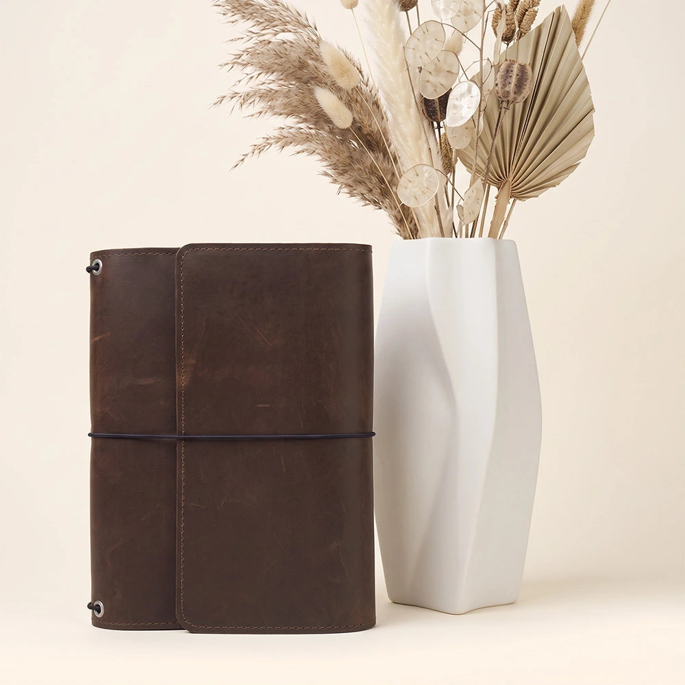 Genuine leather notebook protector with organized sleeves and reliable leather pen carrying loop.