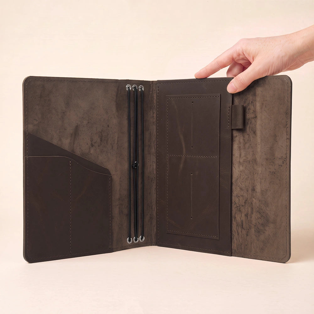 Leather refillable notebook wallet with organized compartments and elegant leather pen sleeve.