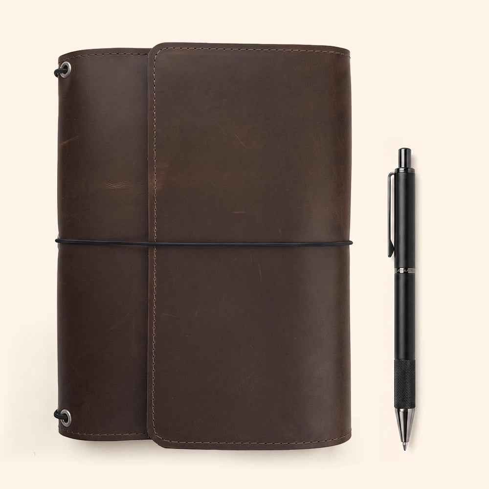 Premium leather journal protector with accessory storage and integrated stitched pen holder.