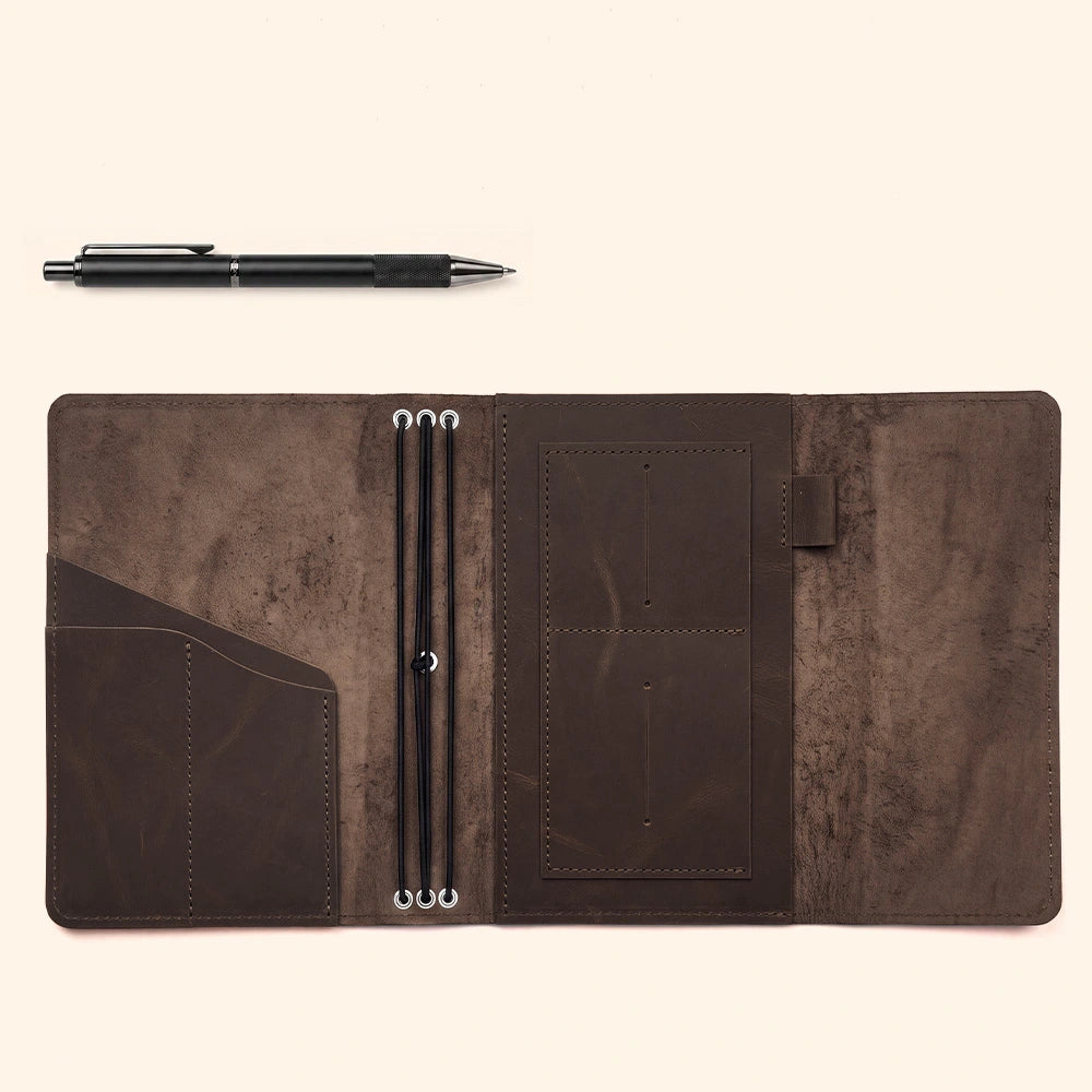 Leather travel journal cover with card pockets and dedicated leather pen strap inside.