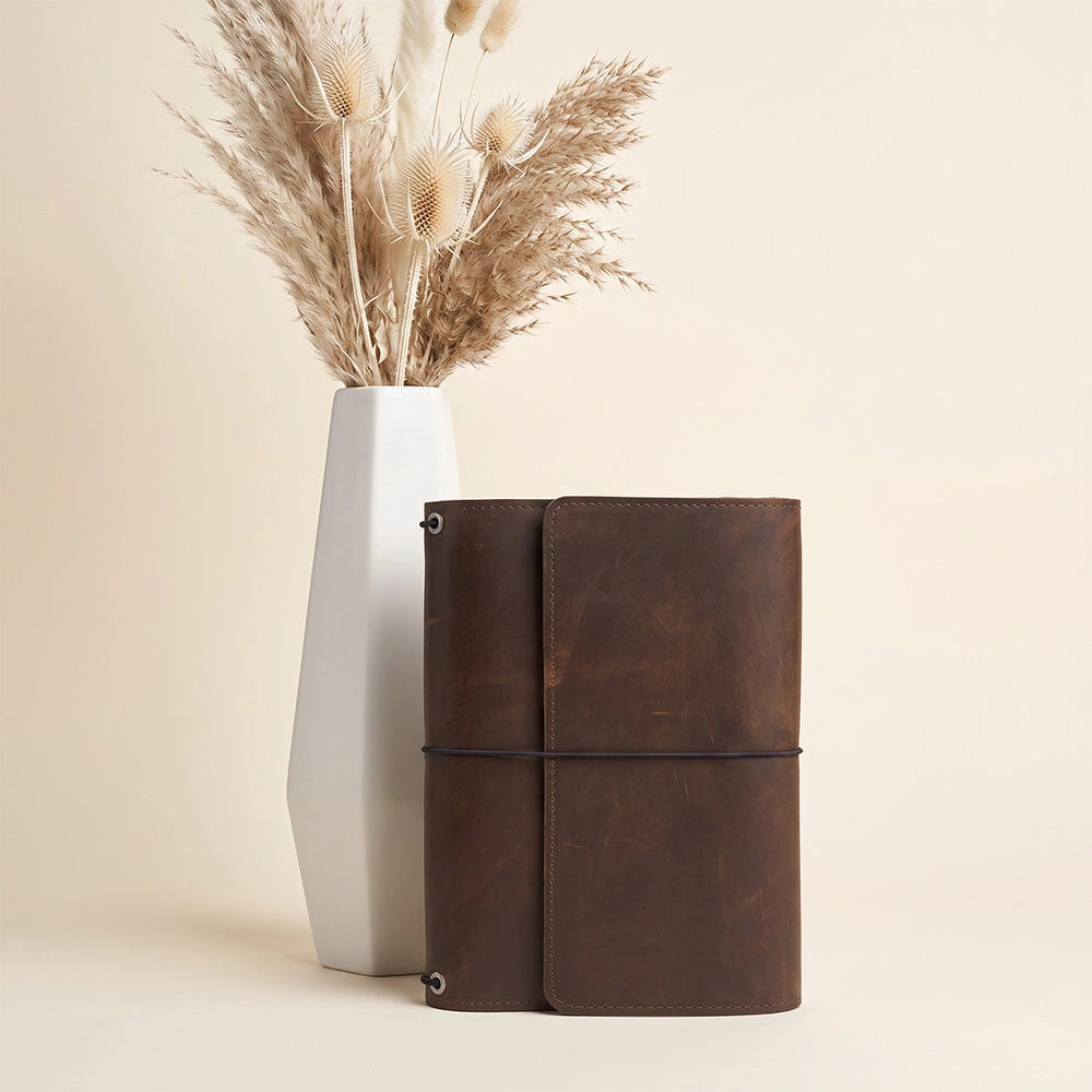 Premium notebook cover handcrafted from natural leather with organizer pockets and pen loop.