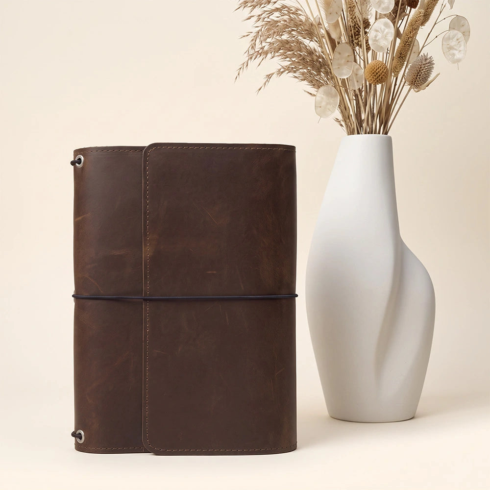 Refillable leather journal folio featuring practical document storage and stitched writing accessory holder.