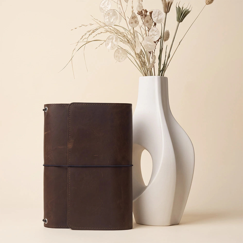 Natural leather notebook cover featuring organizer pockets and integrated pen holder inside.