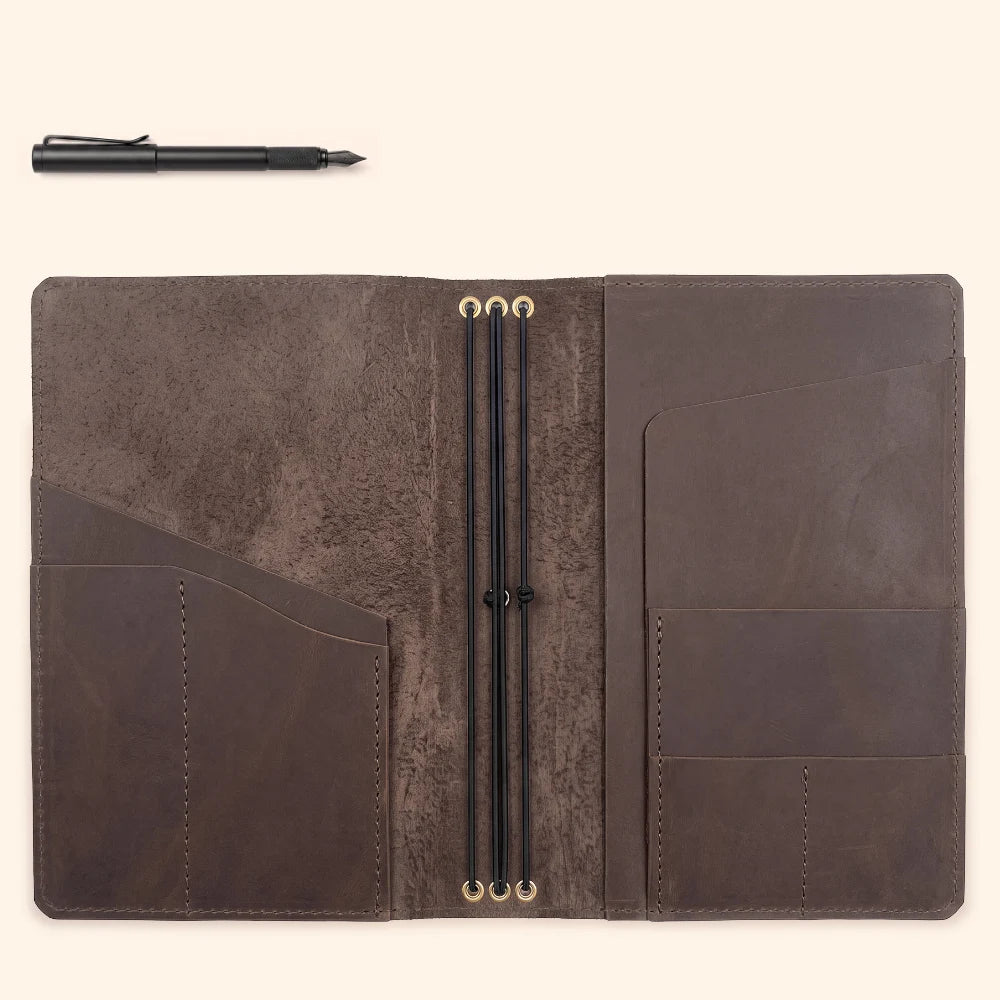 Handmade leather wrap organizing three slim notebooks into one portable system.