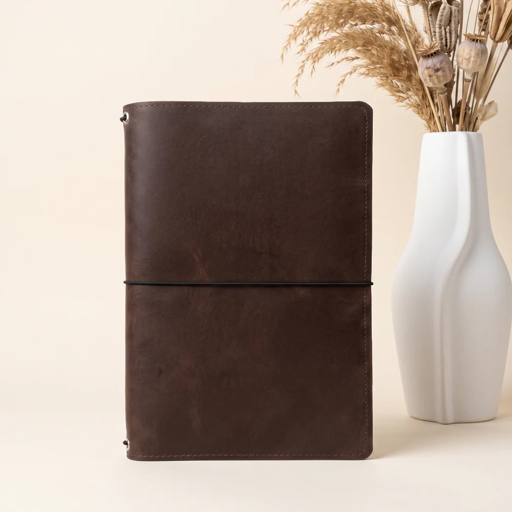 Genuine leather refillable journal cover with three bands for organizing notebook inserts.
