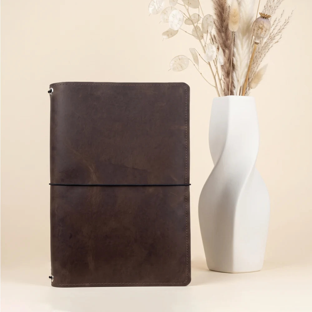 Natural leather wrap with three elastic cords for simple notebook customization.