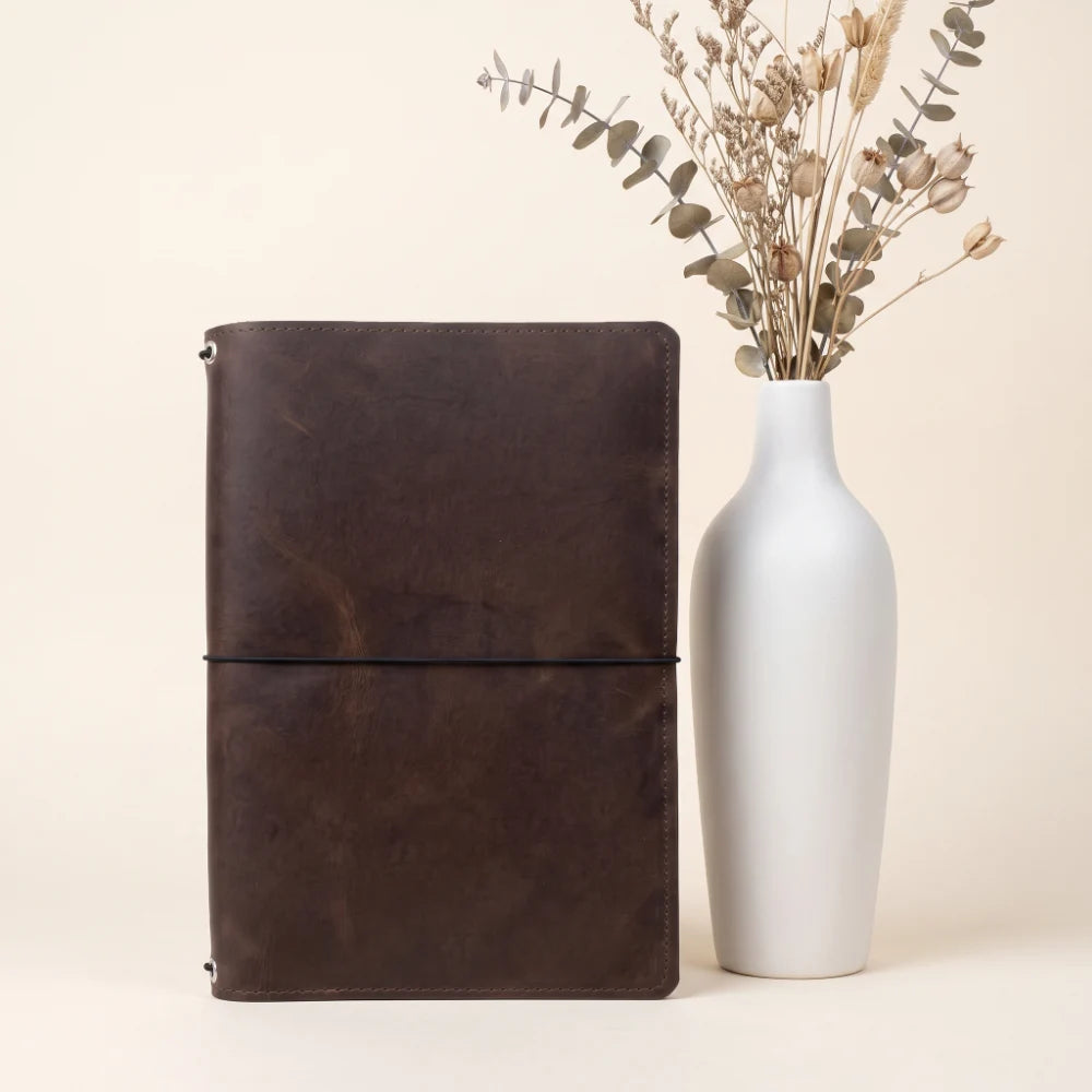 Durable leather notebook holder designed for organizing three refillable journal inserts.