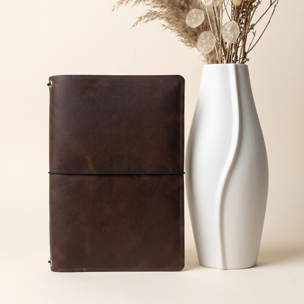 Handmade genuine leather planner cover designed for three interchangeable notebook refills.