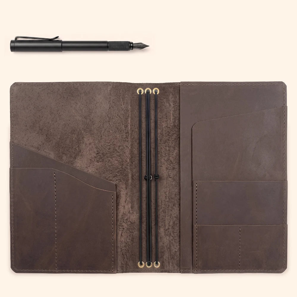 Leather notebook organizer allowing three separate inserts to stay neatly secured.