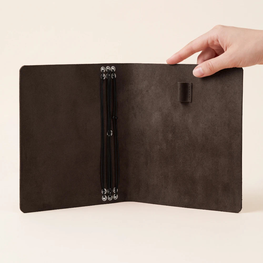 Classic leather journal organizer with six elastic loops and integrated pen holder.