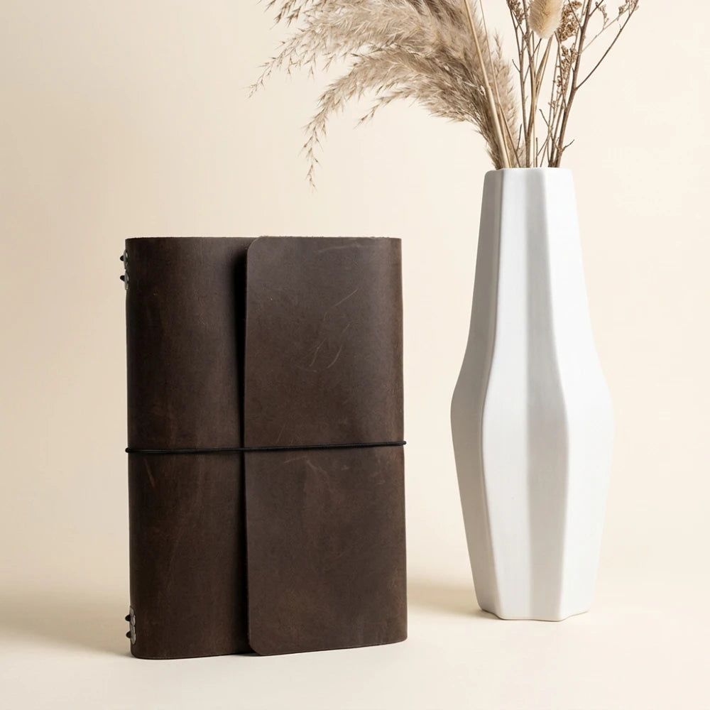 Durable genuine leather planner cover featuring six elastic bands for notebook inserts.