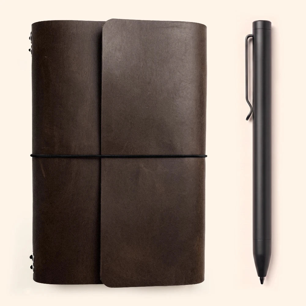 Minimalist leather notebook case featuring six elastic straps and integrated pen holder.