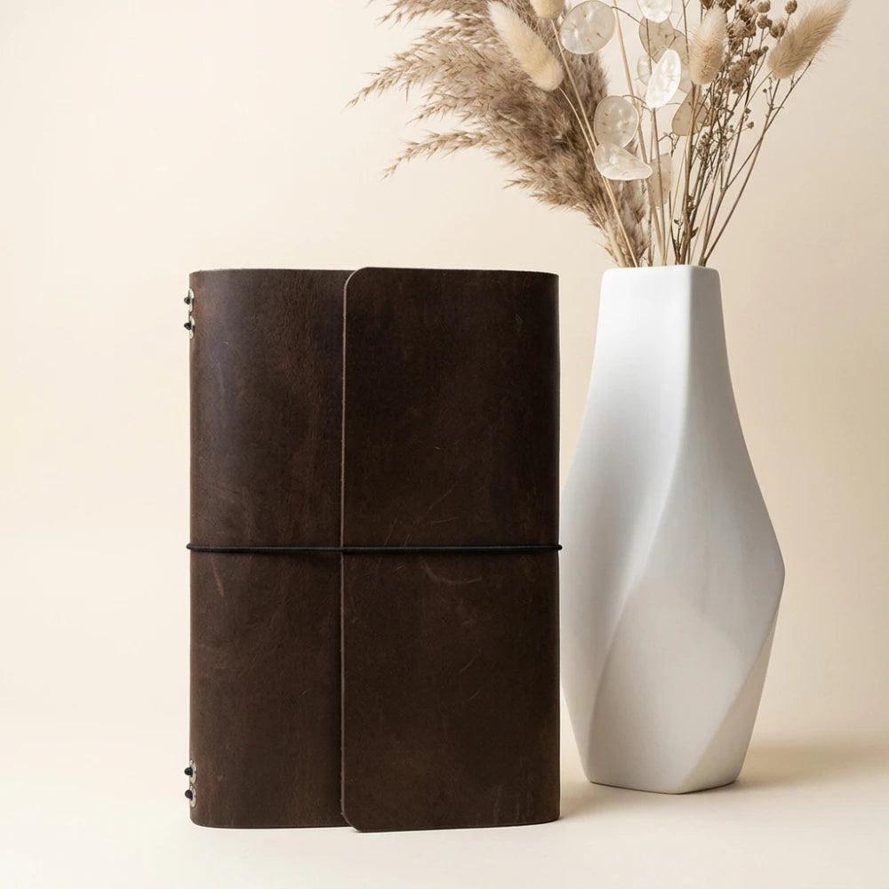 Elegant notebook organizer made from genuine leather with six elastic bands inside.