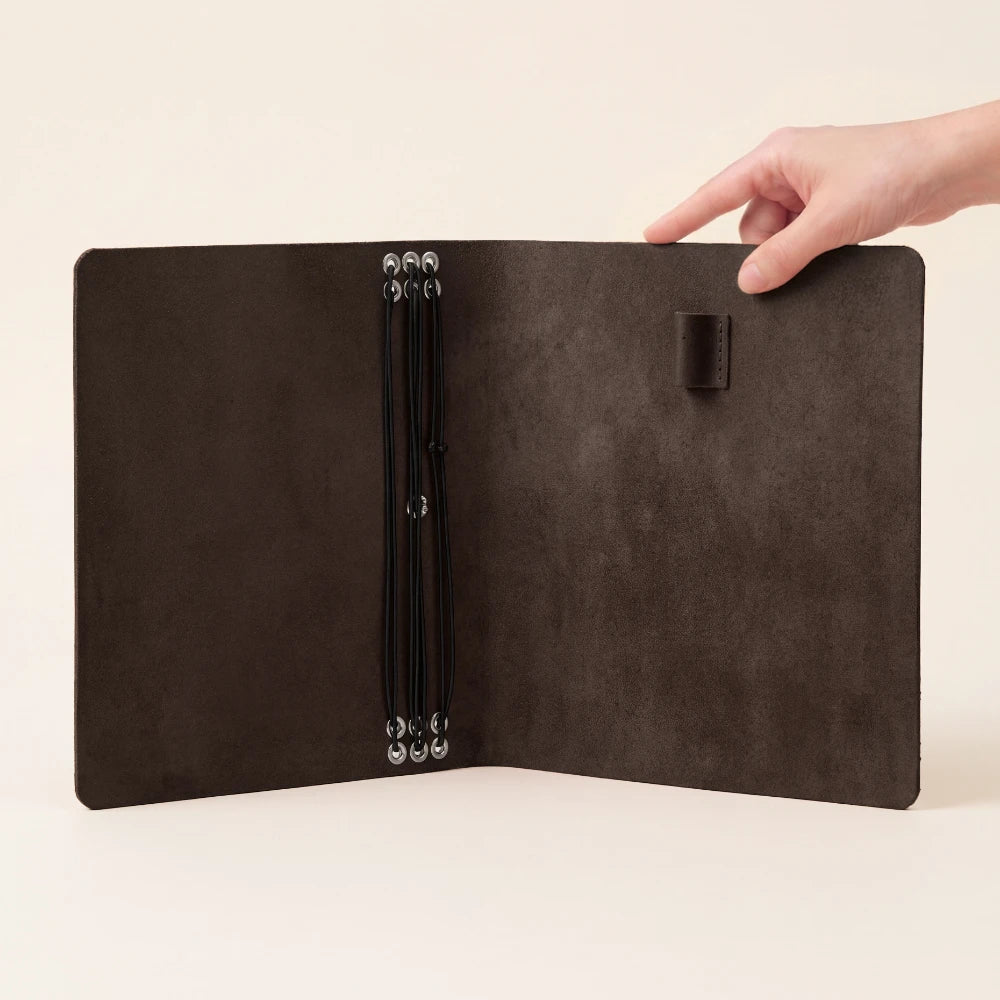 Leather-bound notebook organizer with six stretch cords for neatly separating paper inserts.