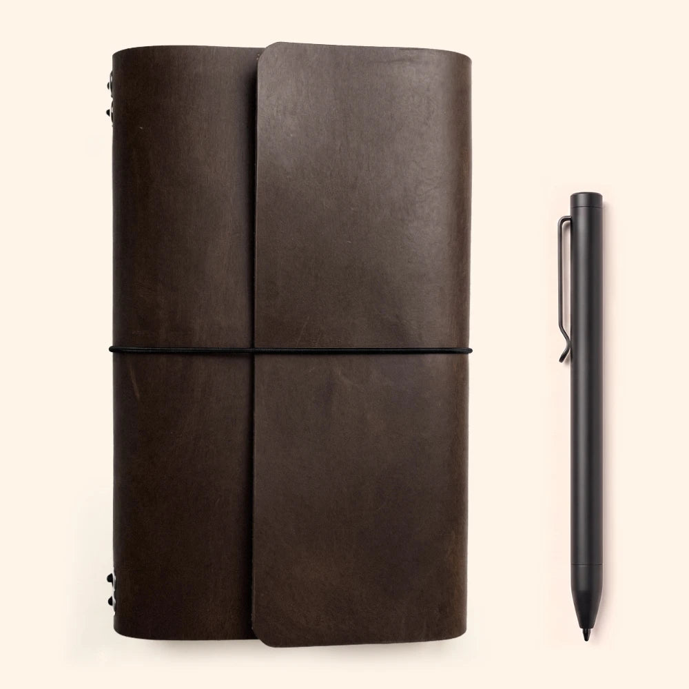 Artisan leather cover designed to keep six slim notebooks together with elastic cords.