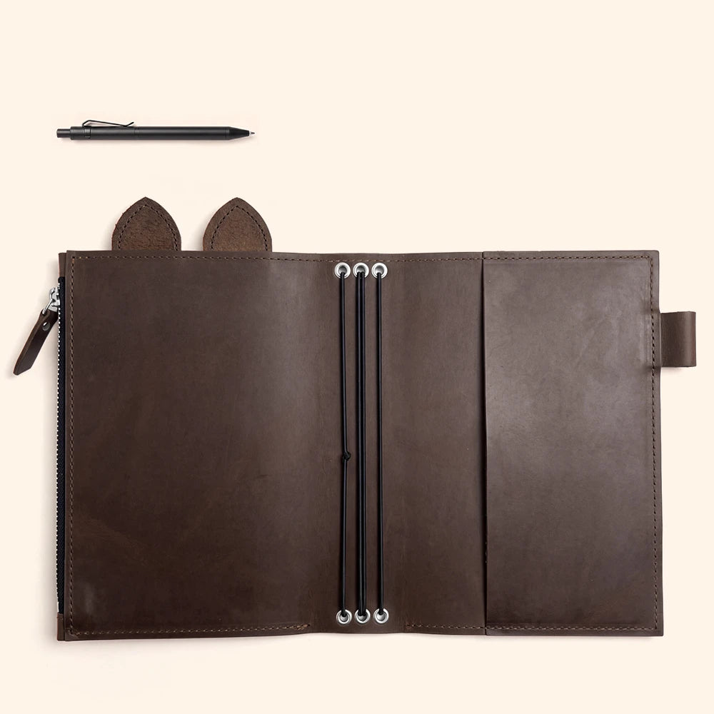 Handmade leather organizer opened flat to showcase flexible elastics and storage features.