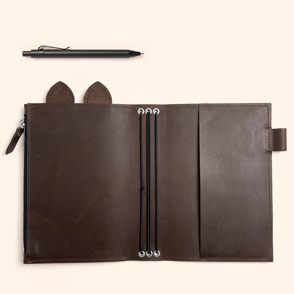 Handmade notebook cover designed to keep multiple inserts securely separated and organized.