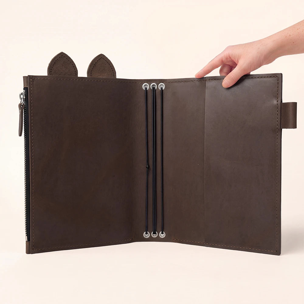 Brown leather journal organizer featuring smooth interior panels and practical zipper storage.