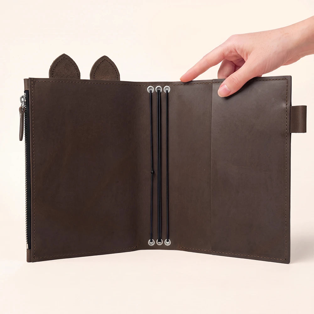 Genuine leather journal organizer combining decorative details with versatile internal storage features.