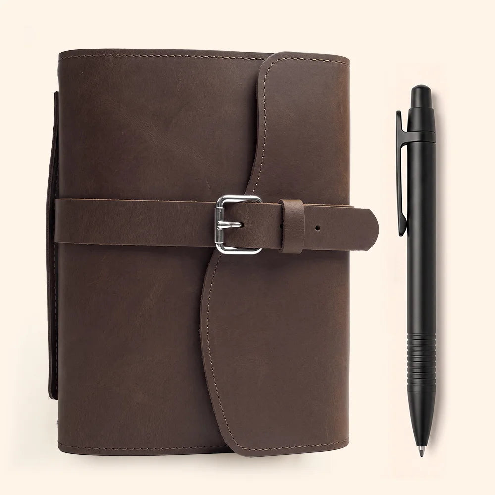 Textured leather journal holder featuring storage slots, elastic pen keeper, attached bookmark, and functional outer handle.