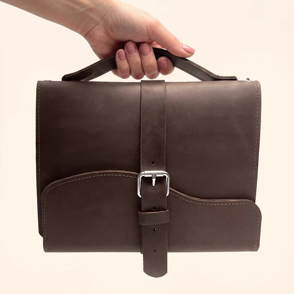 Practical leather travel journal cover with three elastic bands and comfortable carry handle.