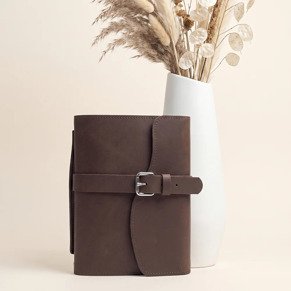Natural leather notebook case showcasing practical compartments, pen holder, bookmark, and durable external carrying handle.