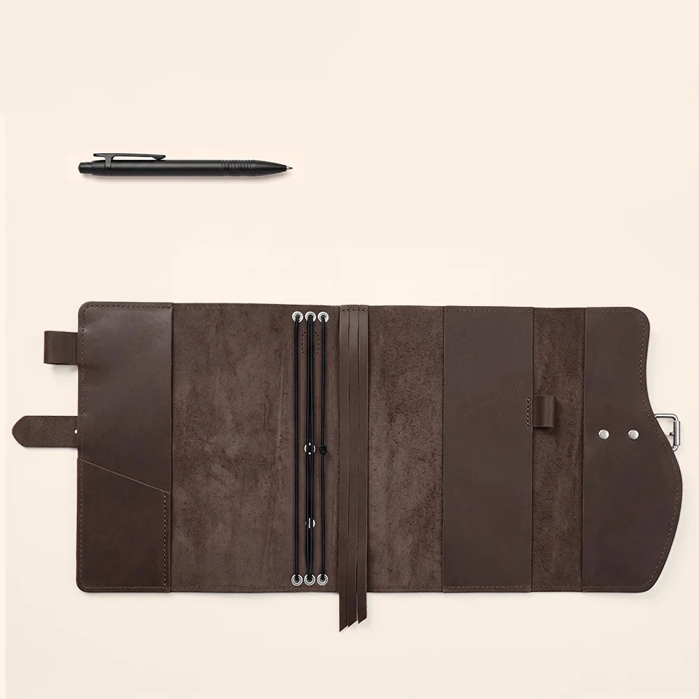 Genuine leather notebook carrier showing interior pockets, pen loop, attached bookmark, and convenient carrying handle.
