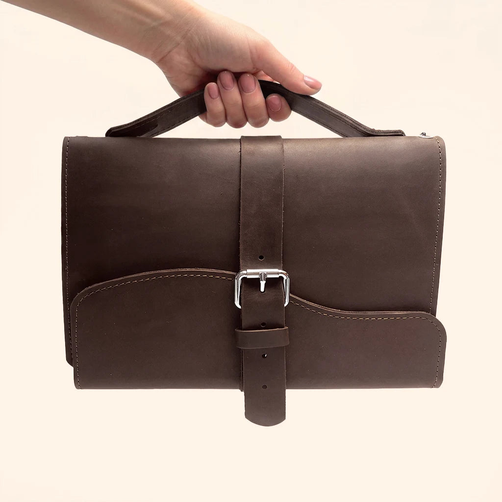 Natural leather notebook holder with three internal elastic loops for refillable inserts.