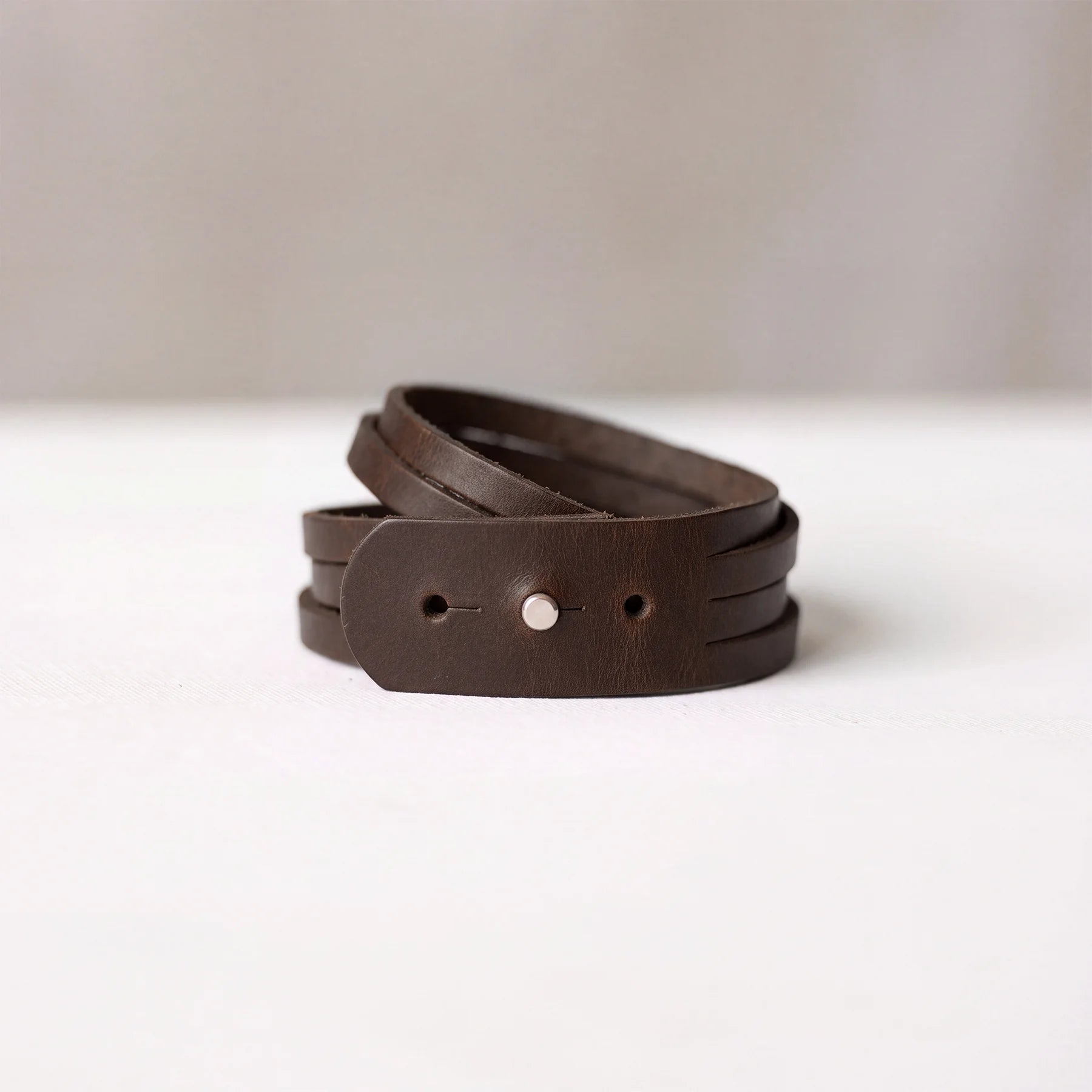 Natural leather wrist bracelet with durable snap fastening and handcrafted premium quality finish.