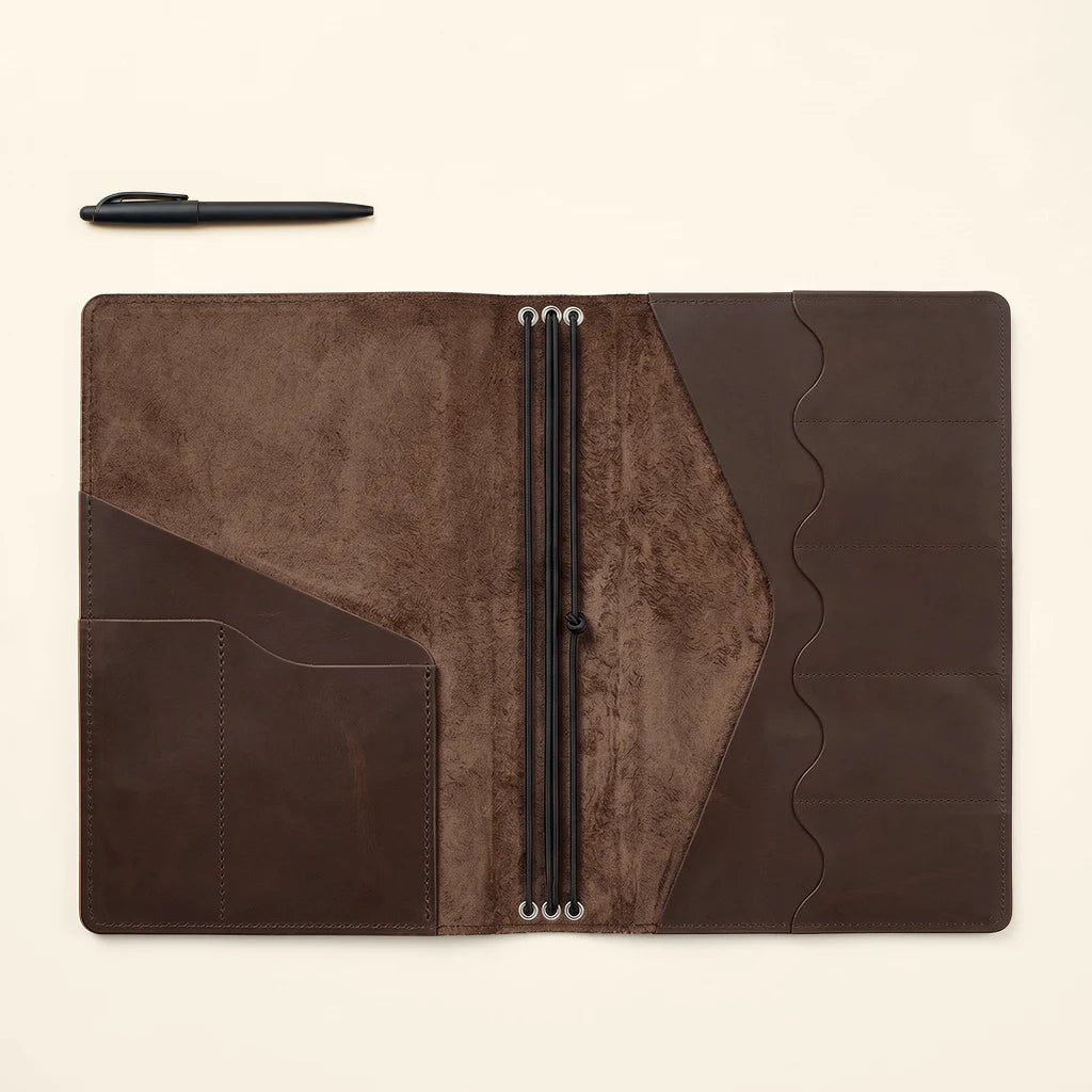 Refillable journal cover with streamlined design and versatile interior storage.