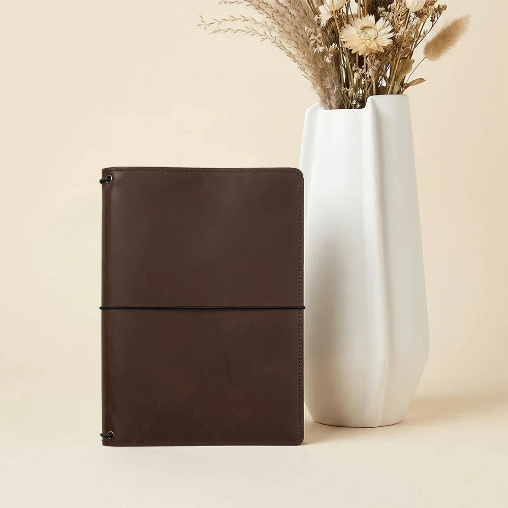Genuine leather notebook organizer with secure elastic notebook loops and card compartments.