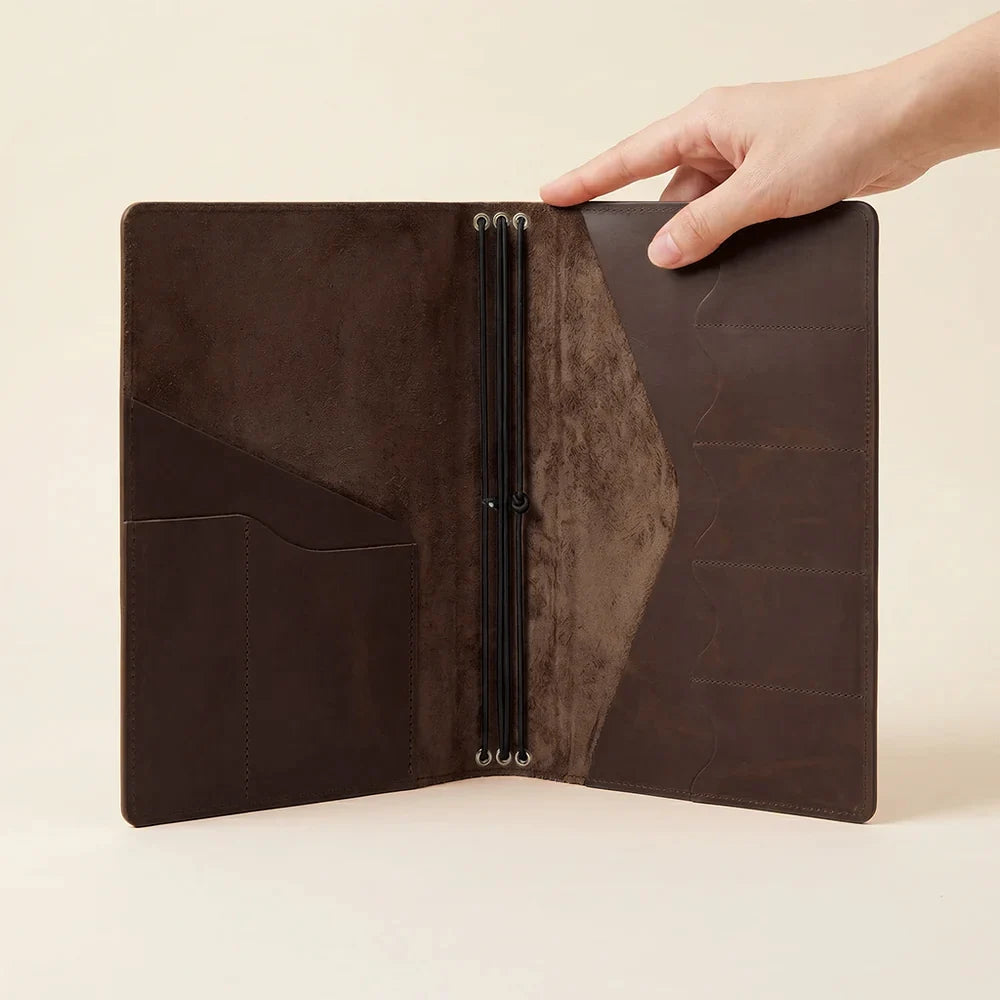 Handmade leather notebook folio designed for refillable journals and organized storage.