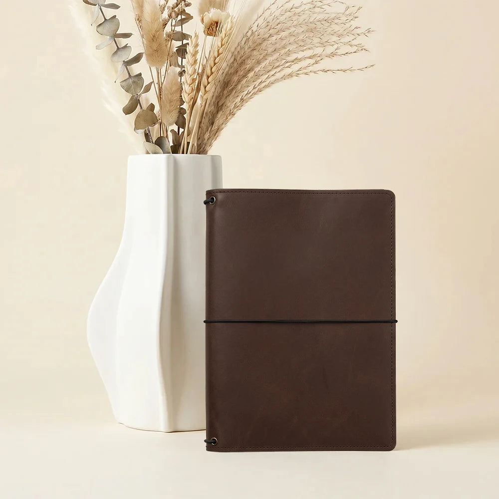 Leather journal folio with multiple storage pockets and three notebook elastic bands.
