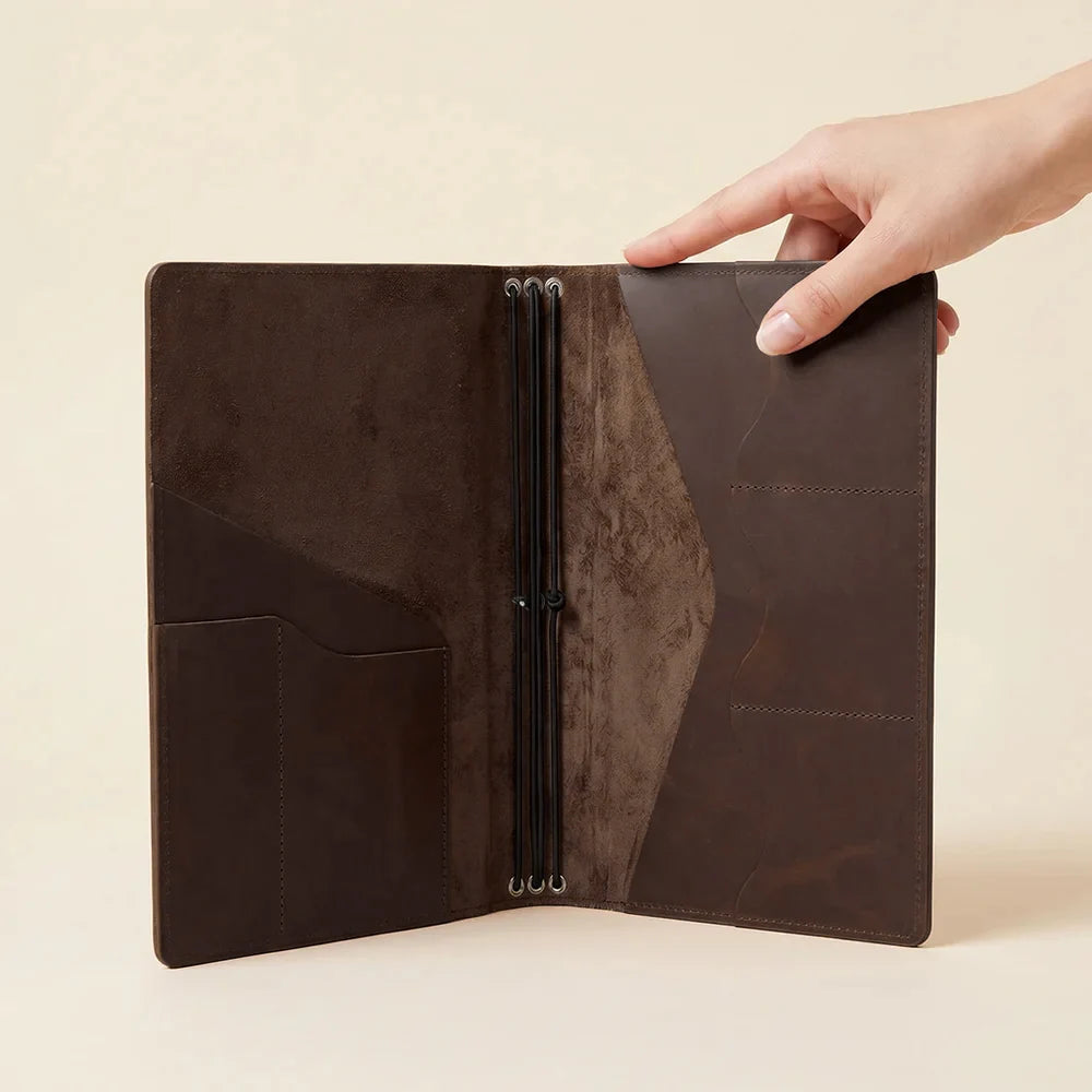 Genuine leather notebook organizer offering refillable notebook storage and interior compartments.