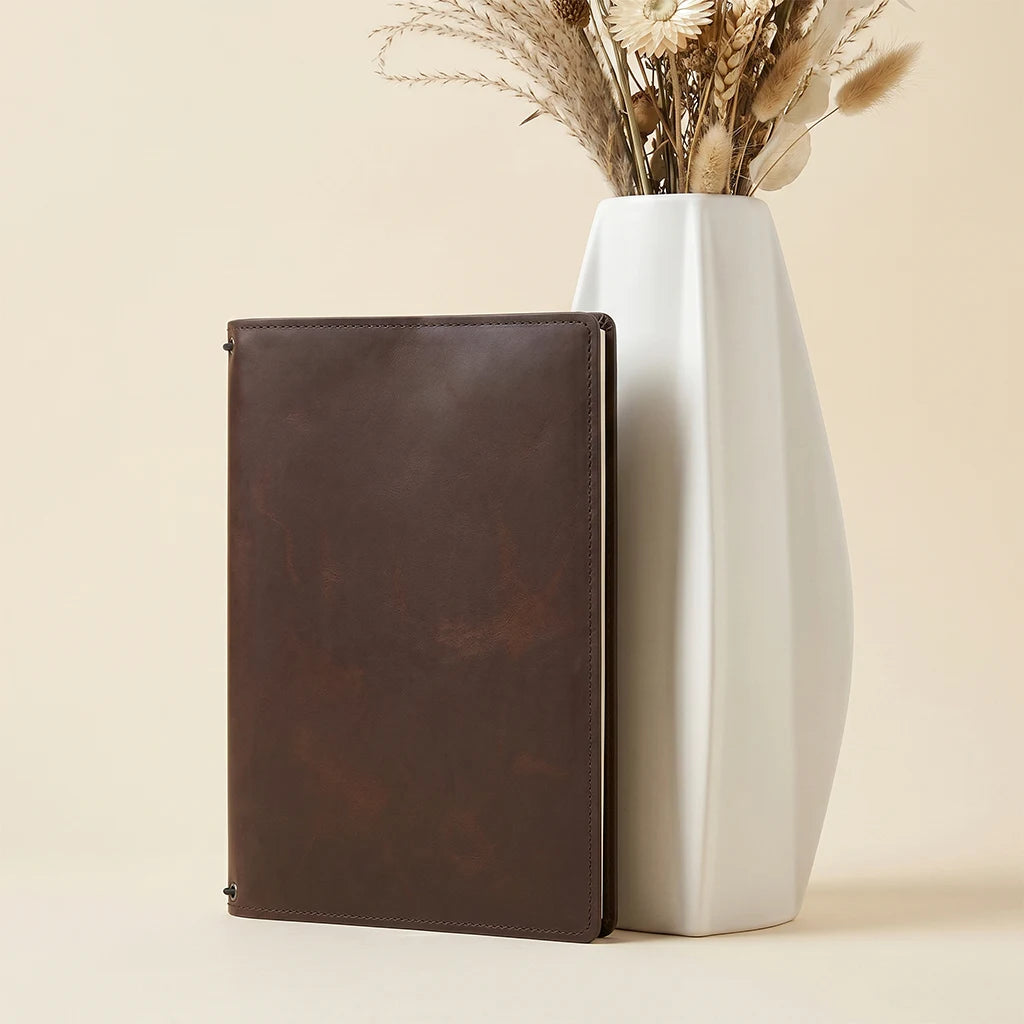 Refillable leather journal organizer with sleek design and interior card slots.