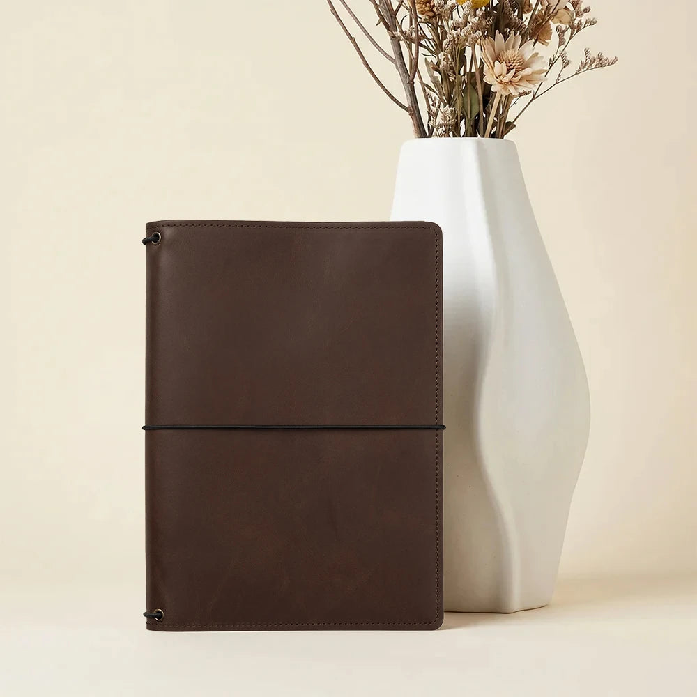 Brown leather journal cover featuring interior pockets and durable three elastic band organizer.
