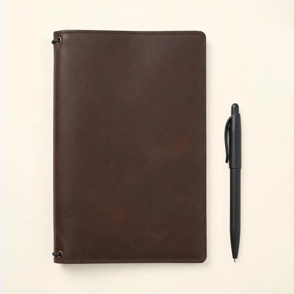 Leather cover system designed to hold multiple notebook inserts securely.