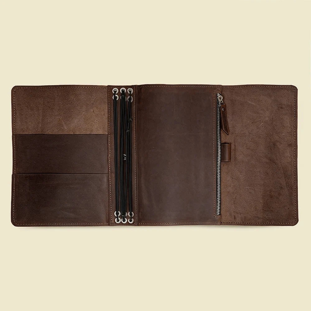 Natural leather journal cover featuring spacious pockets and six secure elastic notebook straps.