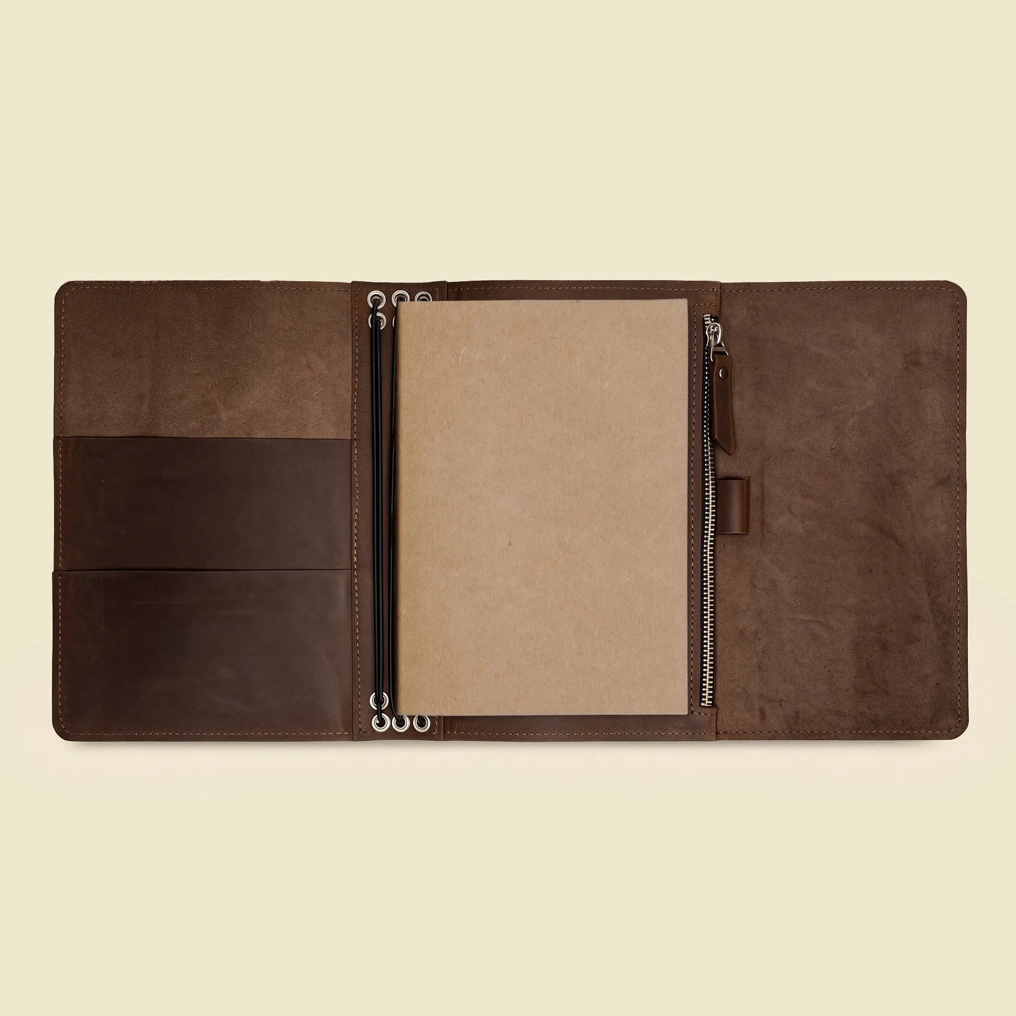 Natural leather writing organizer with space for several journals and one sketchbook.