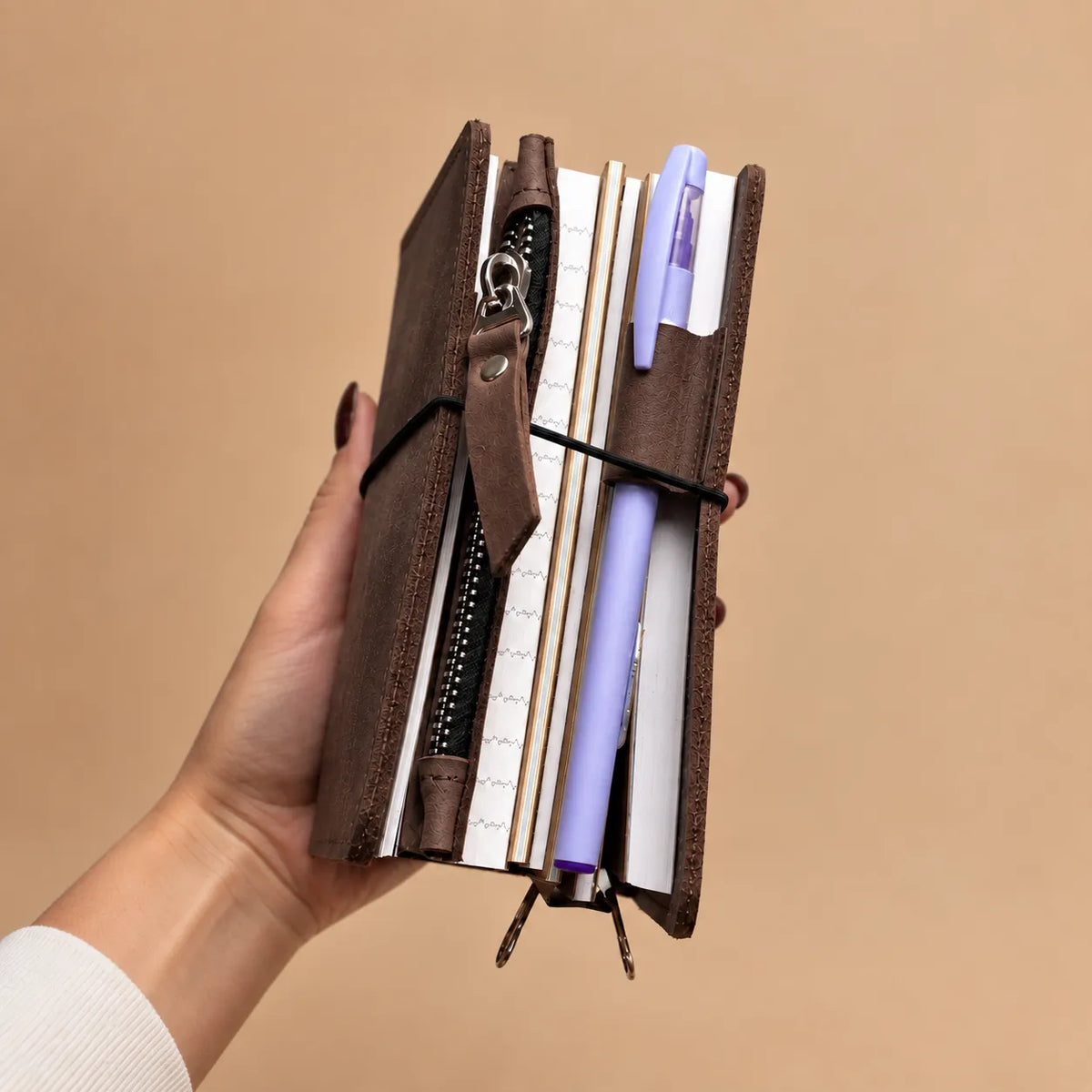 Rustic leather journal cover with five elastic bands and spacious internal pockets.