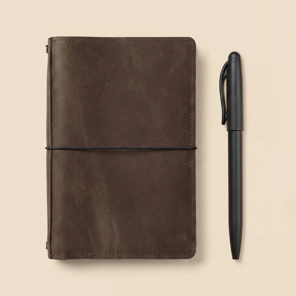 Genuine leather notebook cover featuring durable elastic bands and functional interior storage pockets.