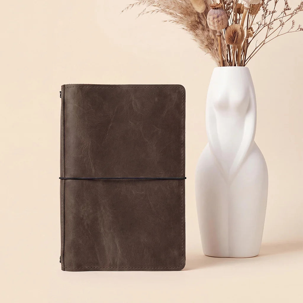 Handmade leather notebook organizer with premium interior compartments and secure elastic notebook straps.
