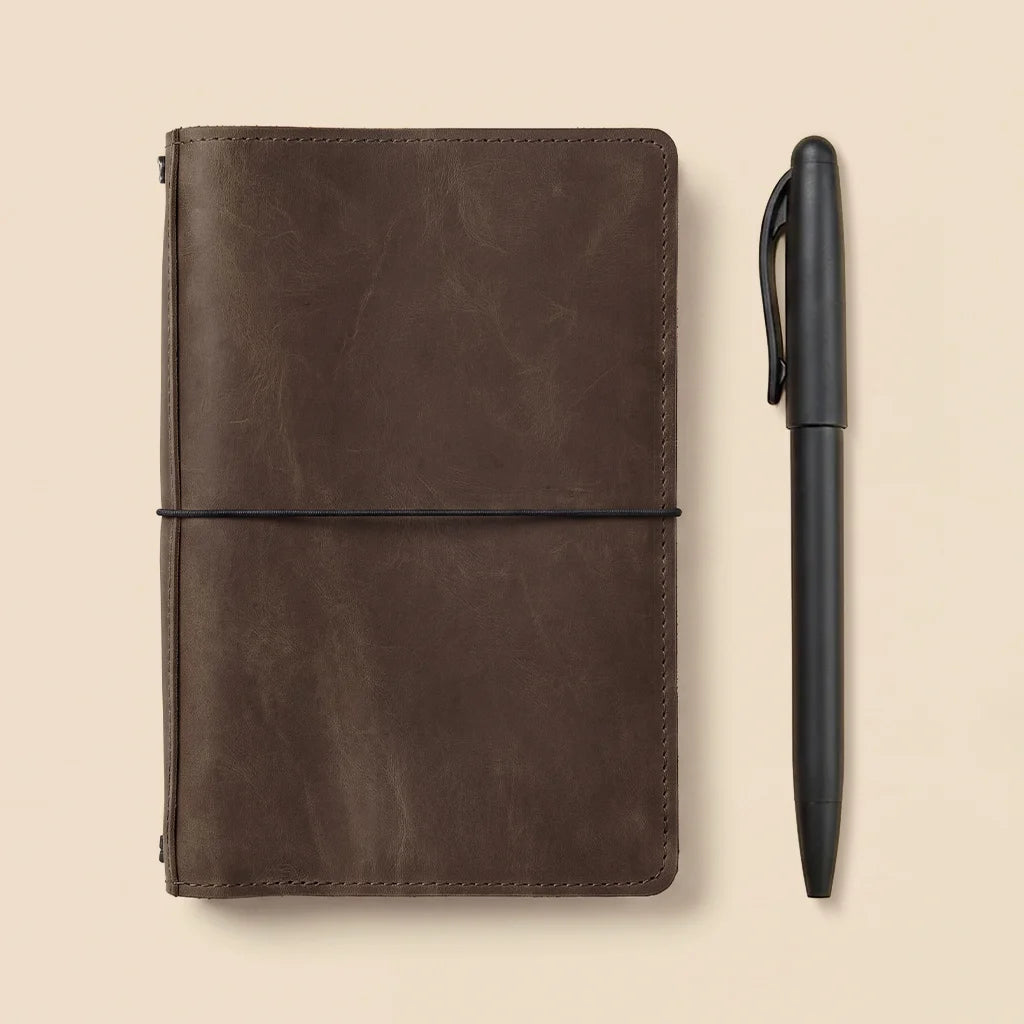 Genuine leather journal organizer featuring interior storage pockets and flexible elastic notebook bands.