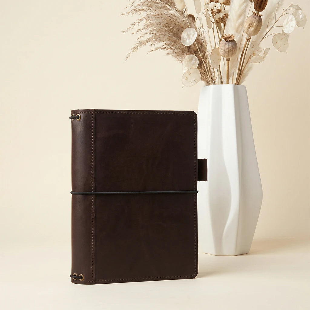 Artisan leather journal holder featuring pocket organizers and pen loop