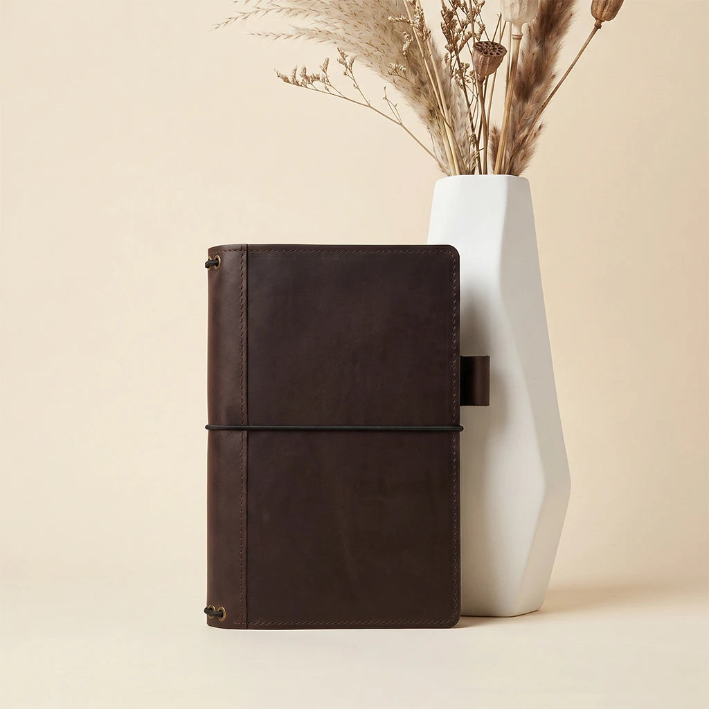 Leather journal organizer with refillable bands and dedicated pen holder inside