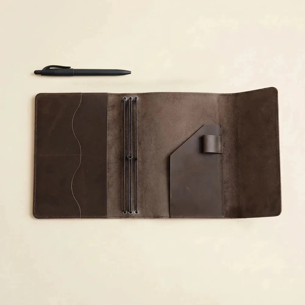 Elegant brown leather travel notebook cover with three elastics and inside document pockets.