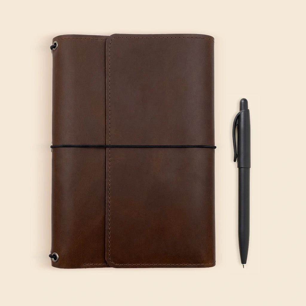 Premium leather journal cover designed with elastic notebook straps and pen loop.