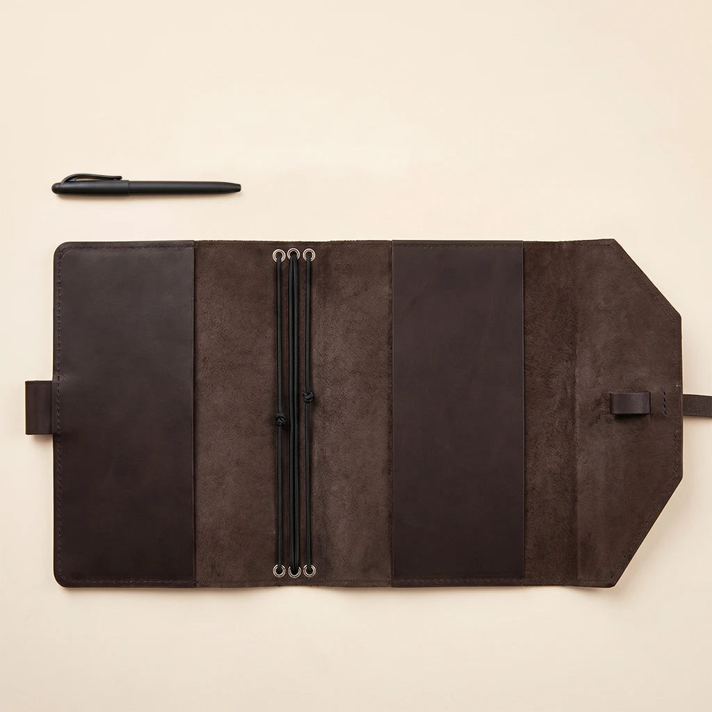 Sophisticated leather journal protector featuring elastic straps for added security.