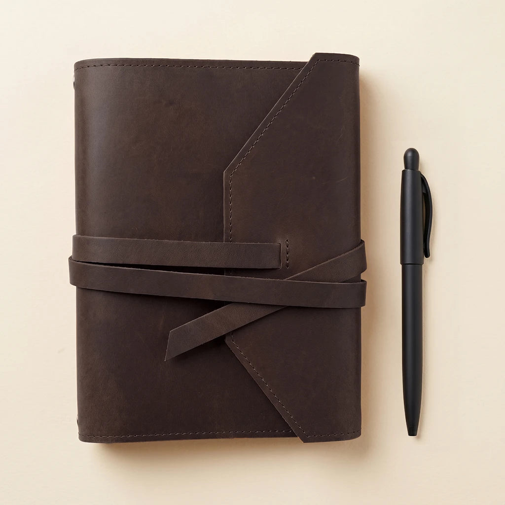 Stylish notebook cover in genuine leather with elastic cords and pen loop.