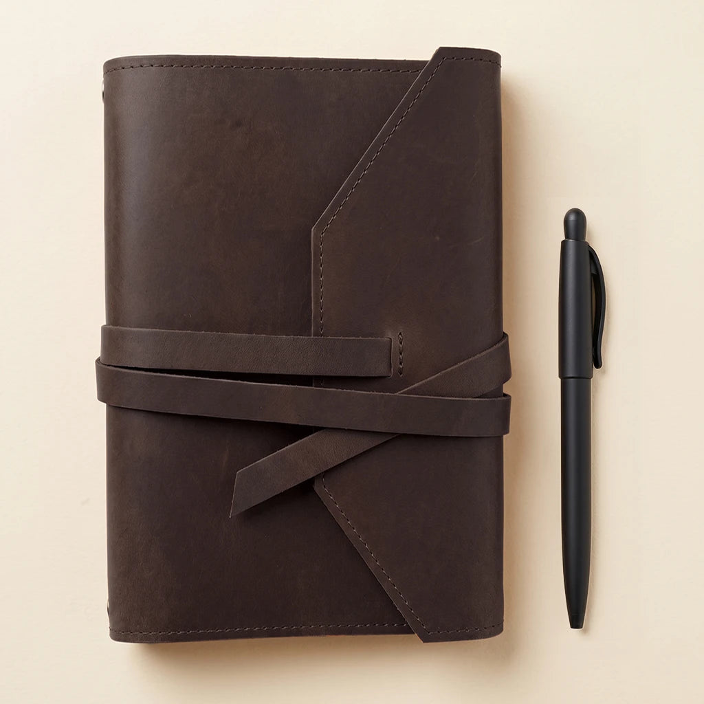 Stylish leather journal protector with secure elastic bands and pen carrying loop.